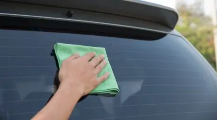 Person Cleaning Car Windows