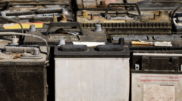 A pallet load of old, dead car batteries waiting for recycling