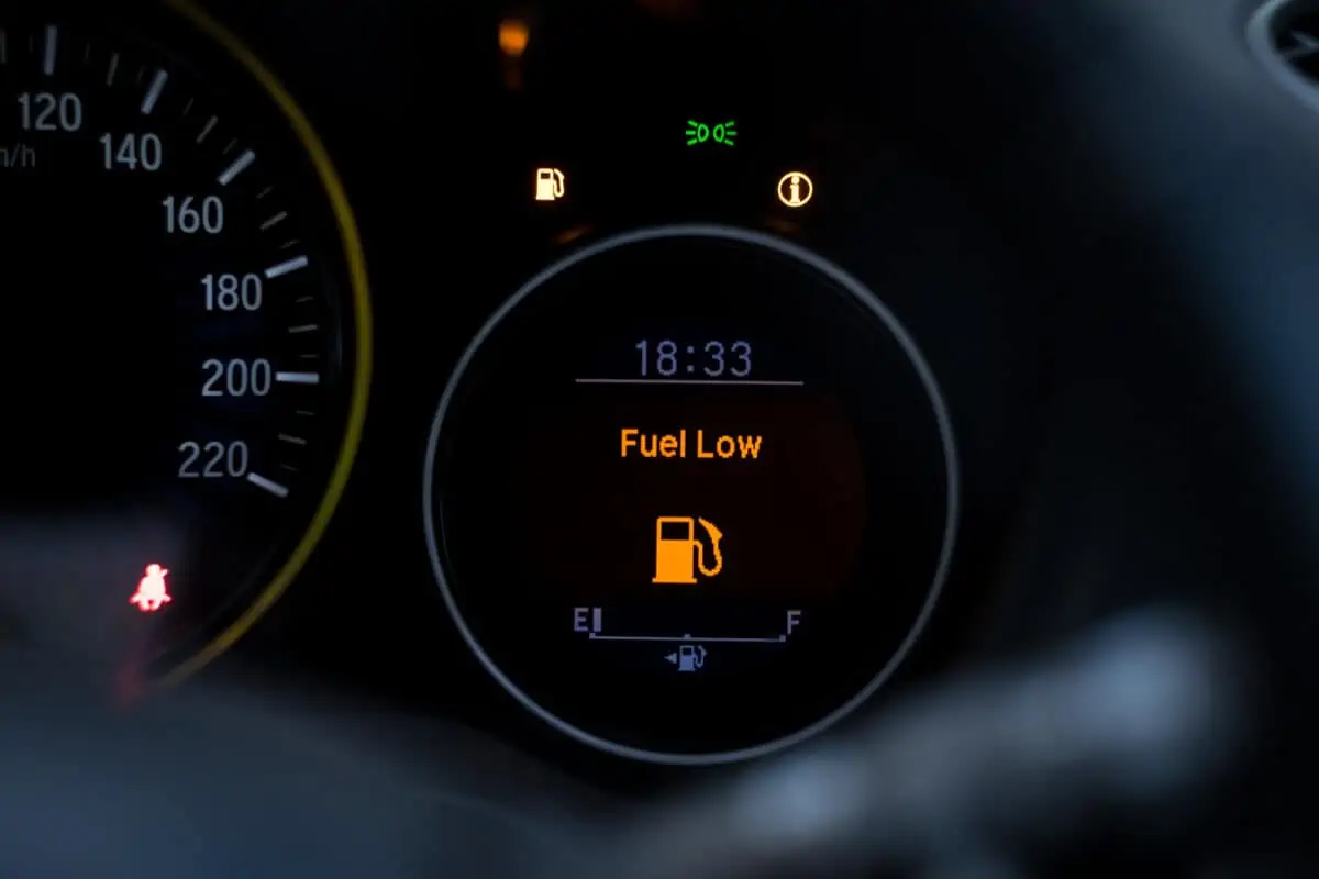 A digital fuel gauge showing that the car is running low on petrol