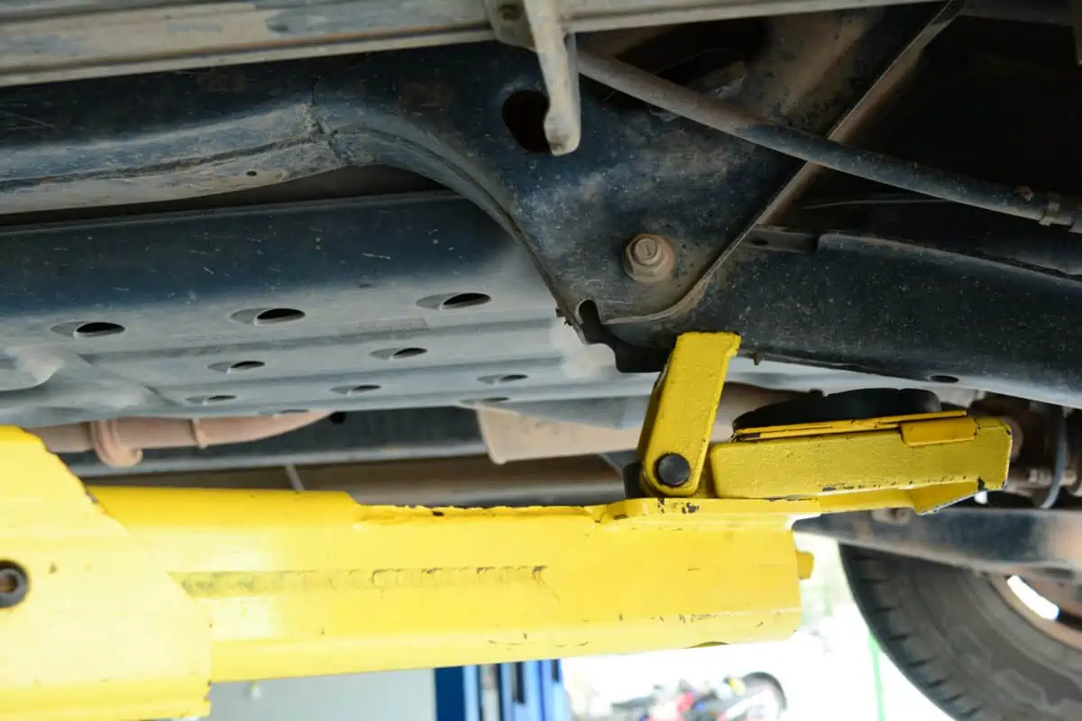 Yellow jack under a car, on the front wheel lifting point