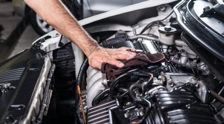 mechanic cleaning a car engine