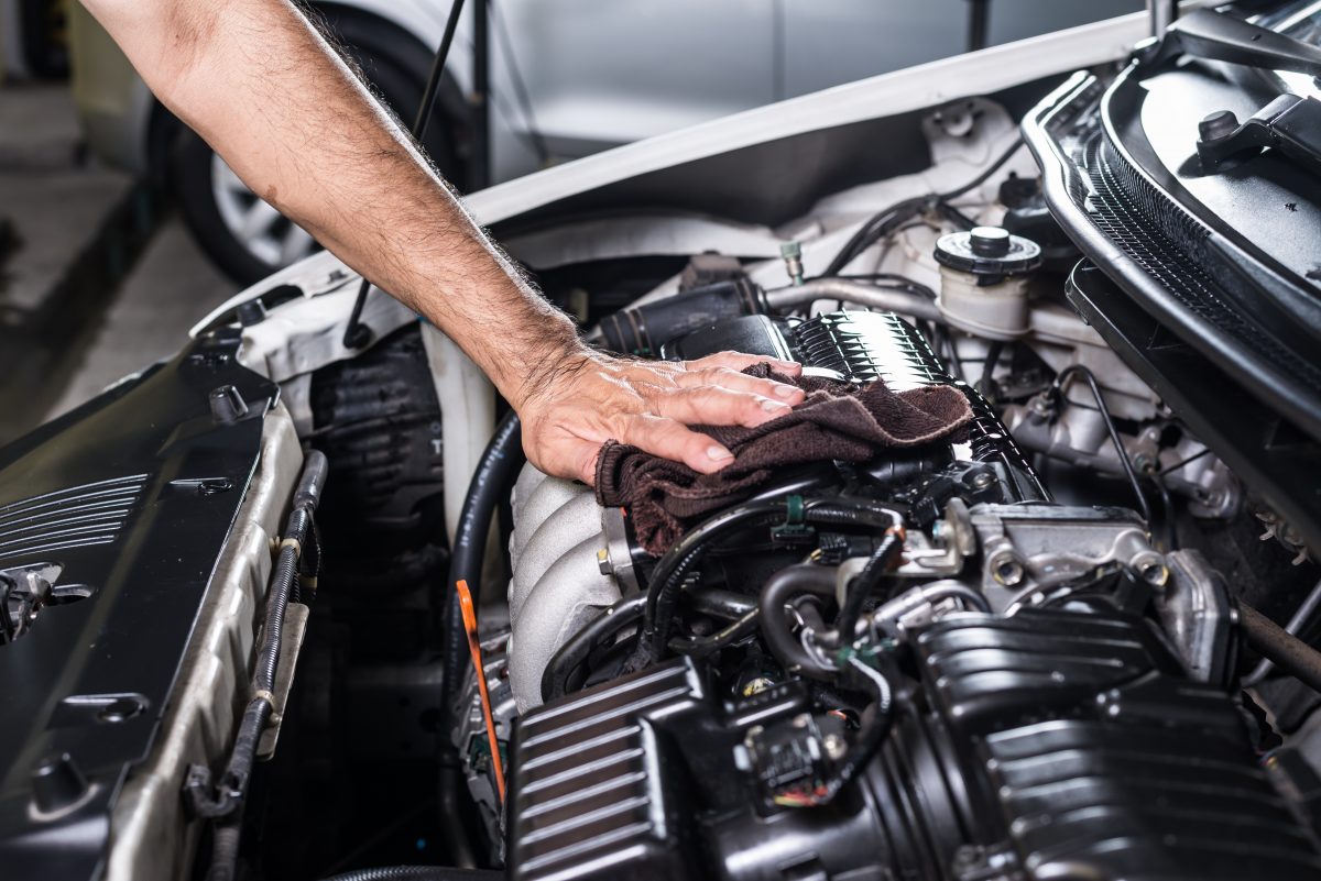 mechanic cleaning a car engine