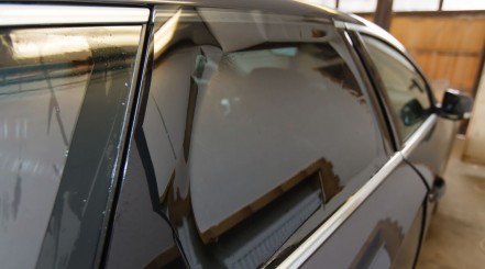 Side view of a black car with dark window tint