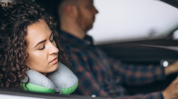 Woman using Neck Pillow in Car