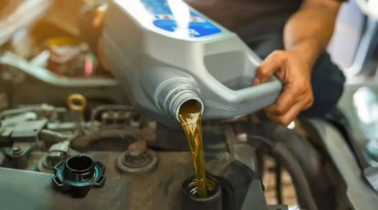 Car Getting Oil Changed by Man