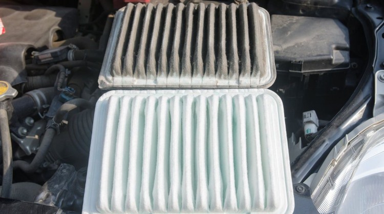 Picture of a dirty, black looking cabin air filter placed next to a clean, white looking one
