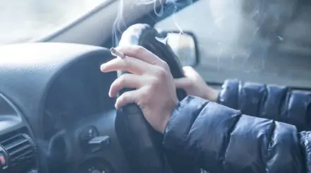 Person Smoking Inside Car Interior