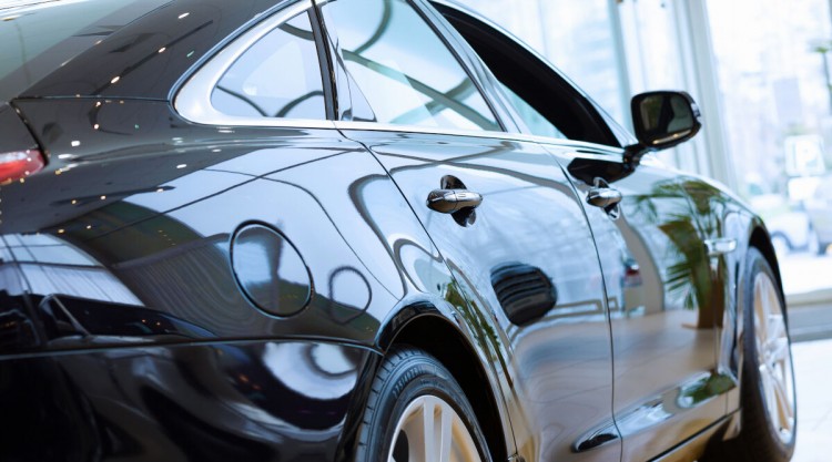 Close up of the rear left wing of a luxury car showing immaculate clear coat