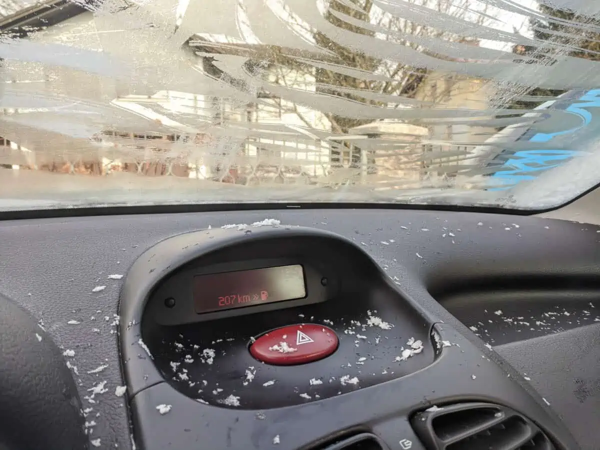 a car interior in winter, with ice on window