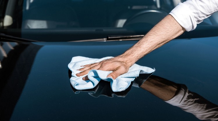 Man wiping his car