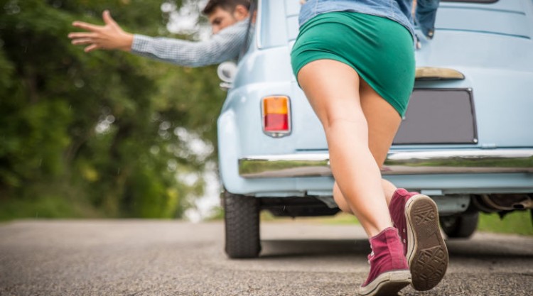 Man and woman bum starting a car with a bad starter