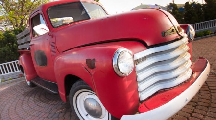 Rust on 2 panels of an old, red classic car