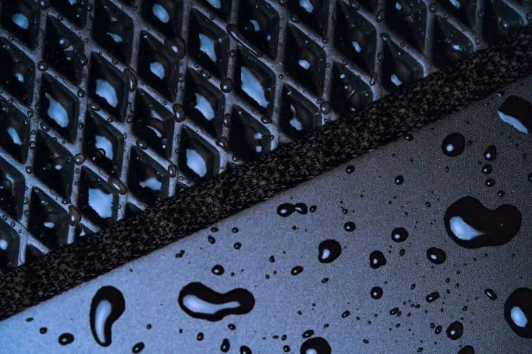 Close up of tread on all weather car floor mat with water beaded up on surface
