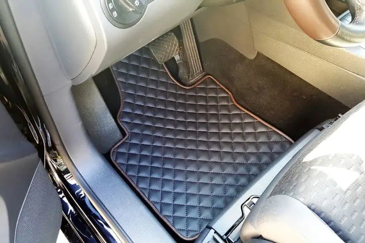 Handmade leather floor mat tailored to drivers seat interior