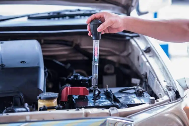 Man using a car battery hydrometer