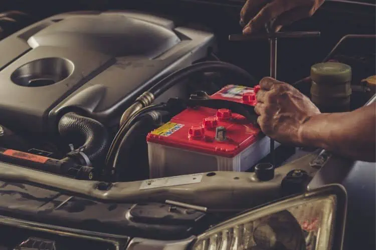 Mechanic fitting a new car battery 