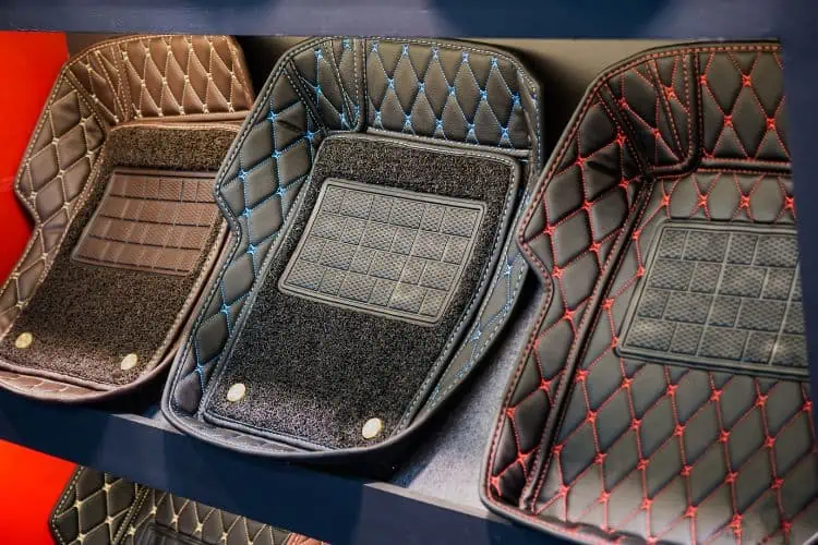 Selection of car floor mats with varying colors of stitching 