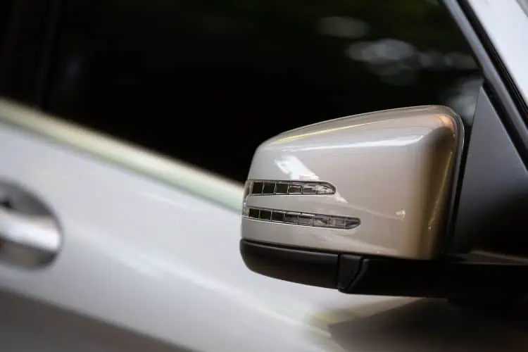 Close up of rear view mirror and black tinted glass