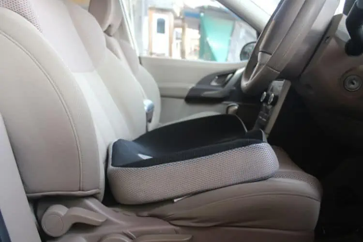 Drivers car seat with coccyx memory foam cushion on it