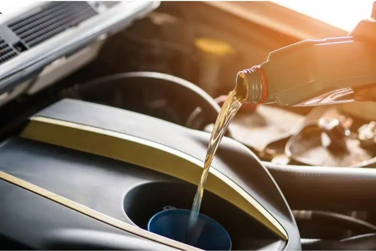 synthetic oil being poured into car