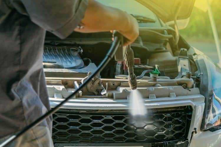 Person cleaning car radiator